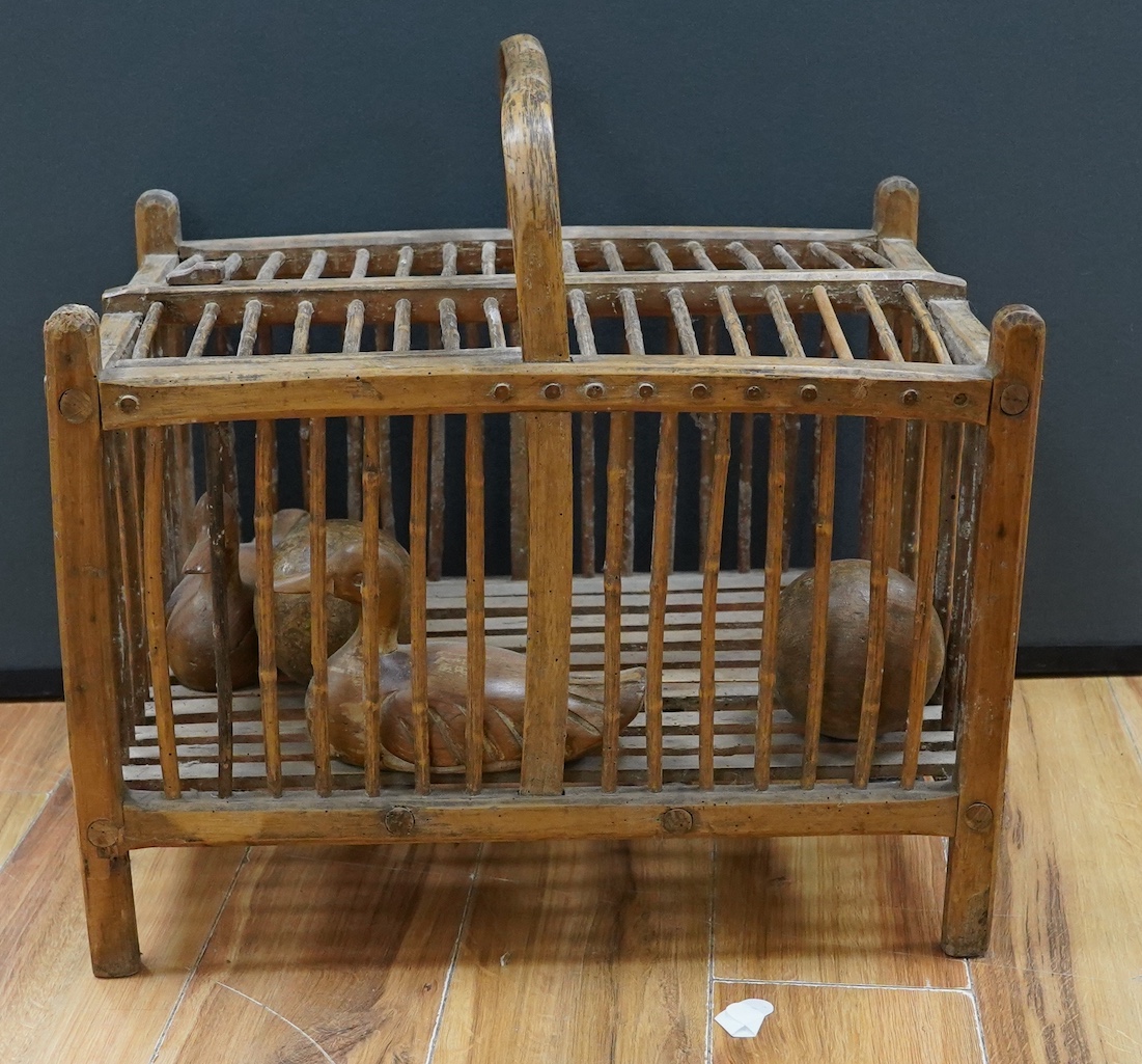 A large wooden chicken carrier with two carved ducks and two balls, chicken carrier 42cm high, 39cm wide, 53cm long